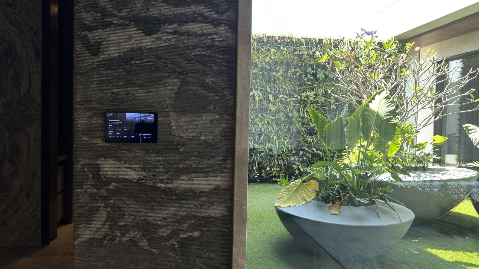Wall-mounted control touchpanel in the courtyard at the Kataria Residence