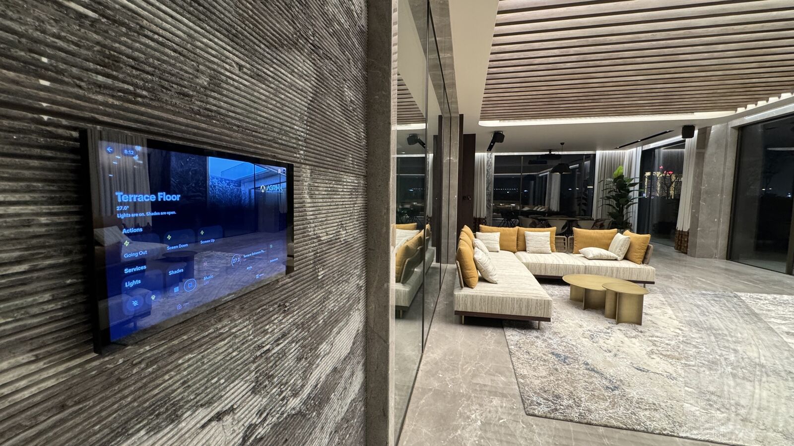 Living area with wall-mounted display and integrated lighting at the Kataria Residence